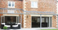 aluminium+glass fixed awning + bifolding doors