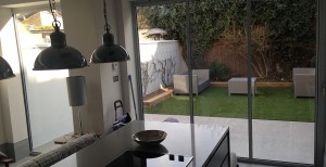 view through ultraslim doors from contemporary kitchen