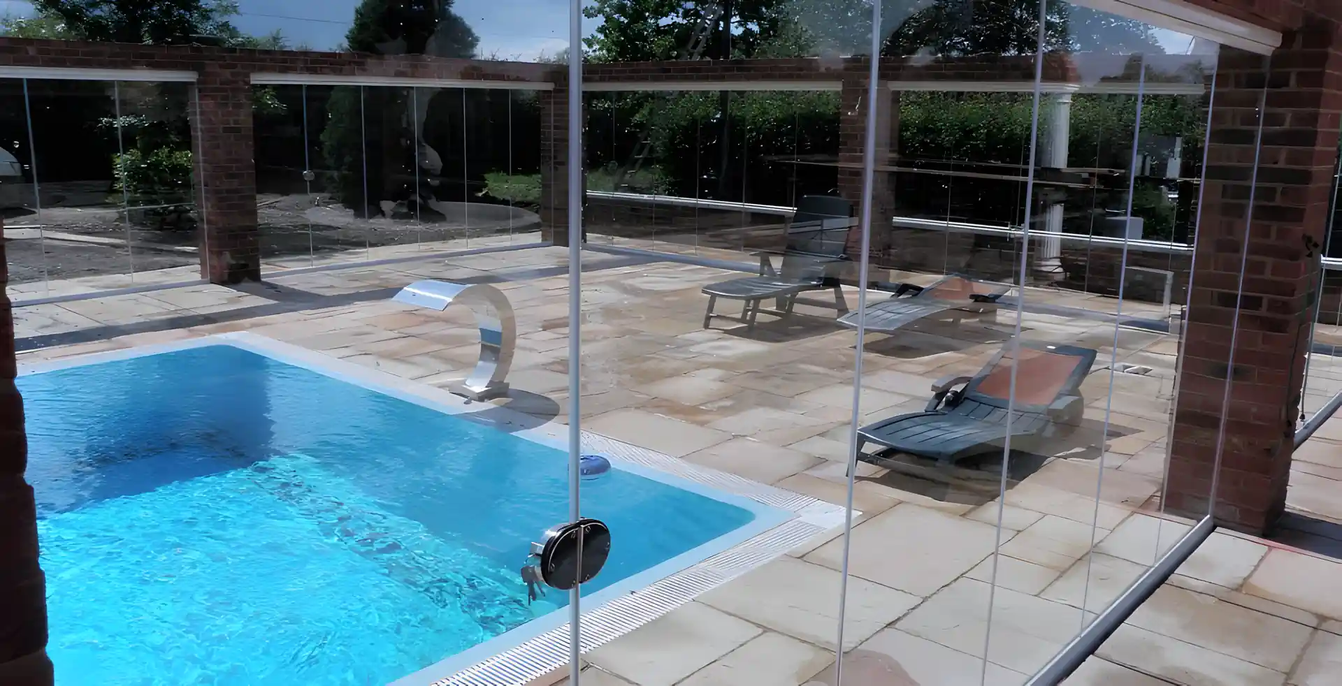 Frameless glass doors pool enclosure by SunSeeker Doors